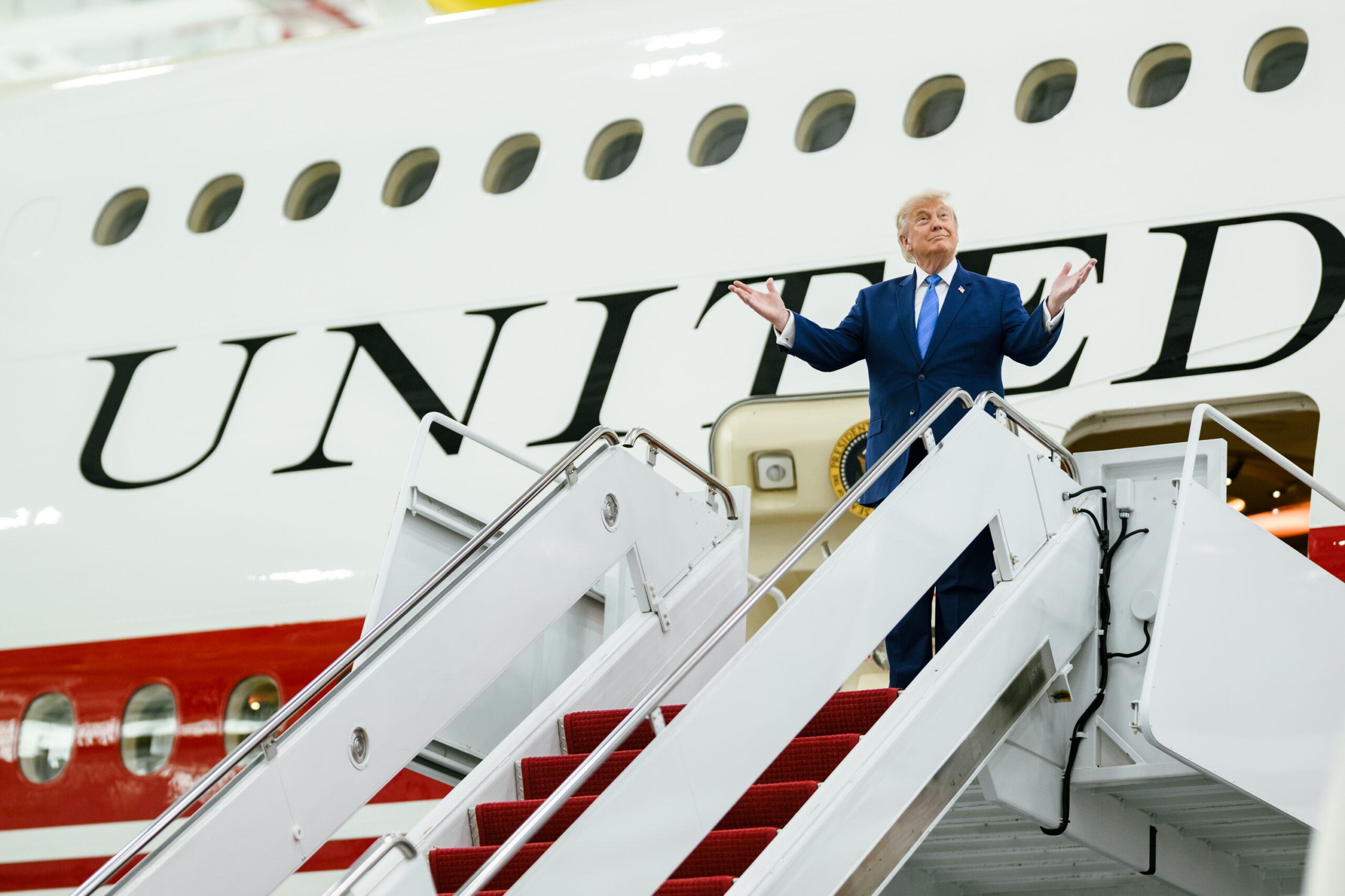 Image of Donald Trump in front of an Air Force One plane.