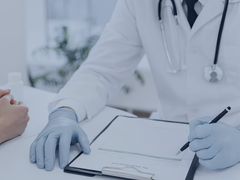 Image of a doctor writing down a patient's information.