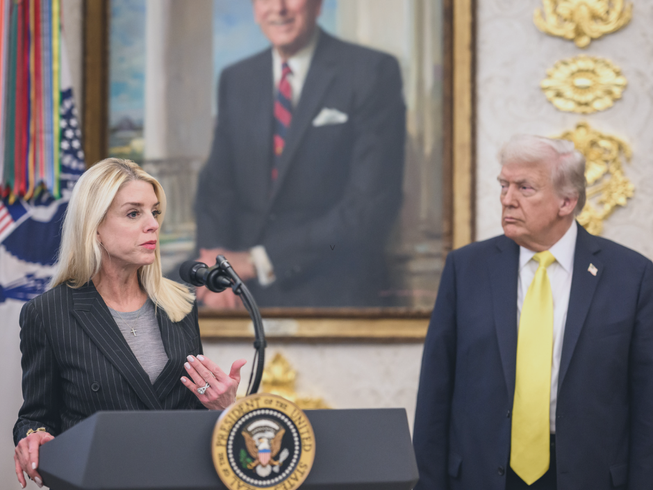 Image of Pam Bondi at a podium next to Donald Trump.