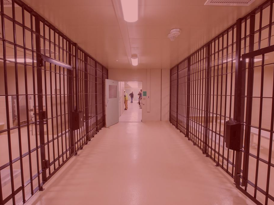 Image of an ICE detention facility with a red filter.