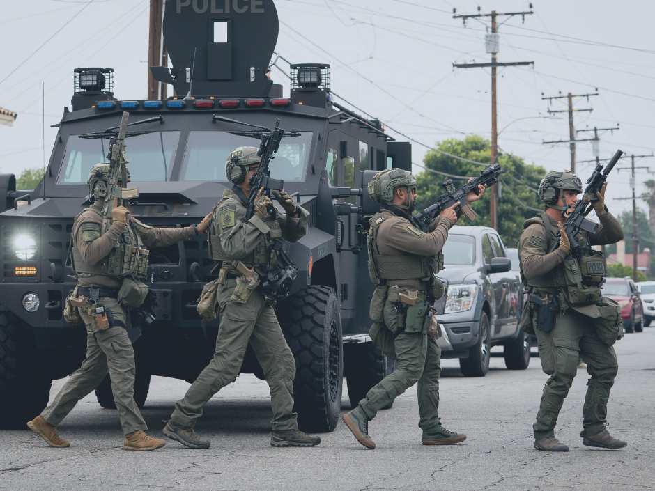 Image of ICE agents with guns.